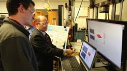 Senator Chris Coons (D?CDE, right) examining equipment at a composite materials laboratory at the University of Delaware in Newark.